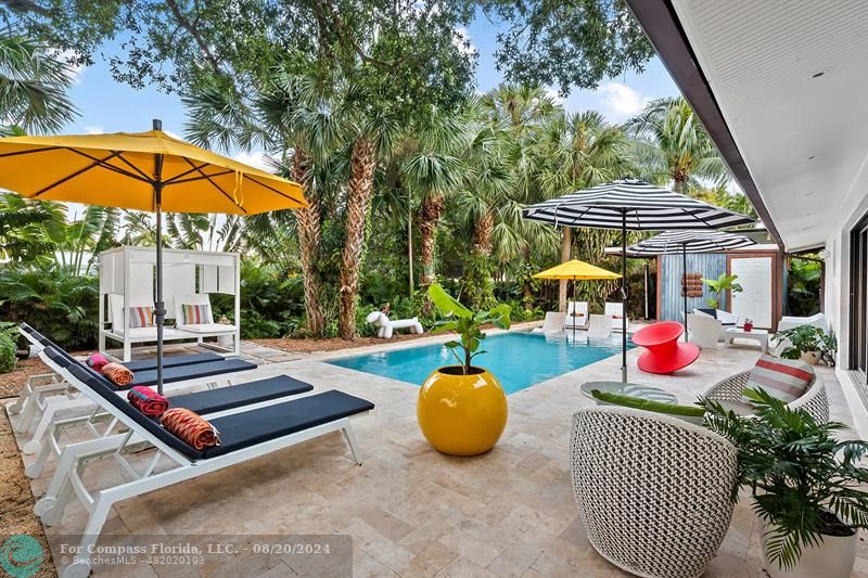 a backyard of a house with outdoor seating