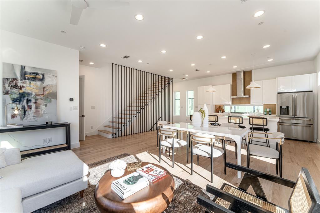 a living room with stainless steel appliances kitchen island granite countertop furniture and a view of kitchen