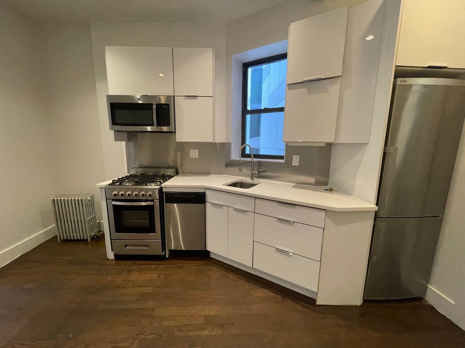 a kitchen with stainless steel appliances a refrigerator sink and microwave