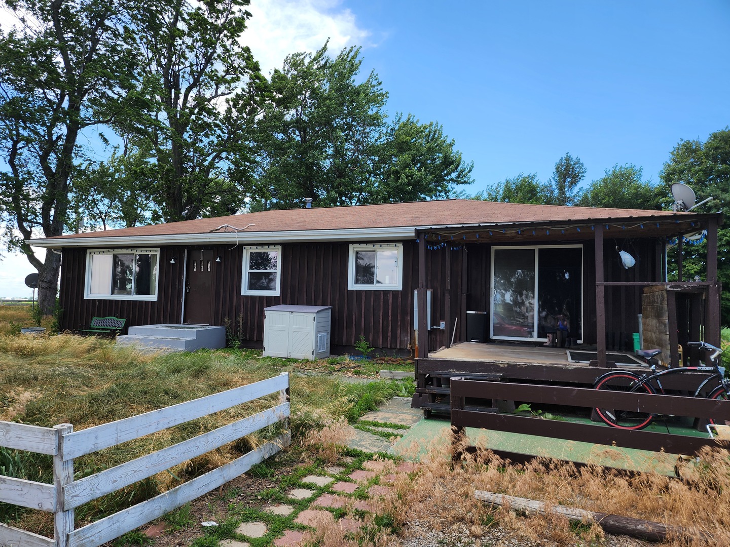 a view of a house with backyard sitting area and garden