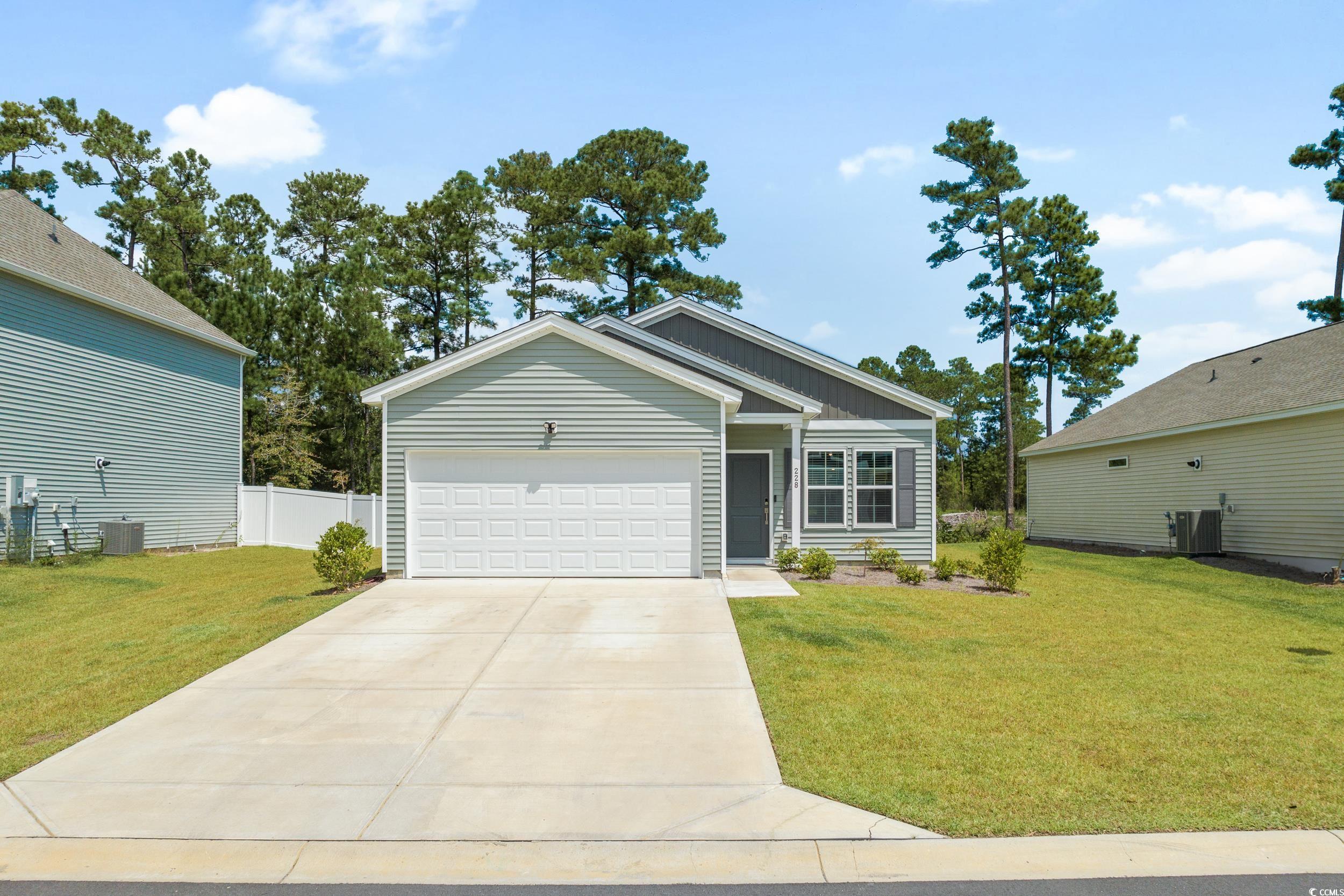 View of front of property featuring a garage and a