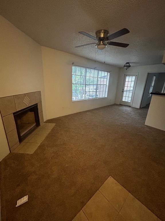 a view of a livingroom with a ceiling fan and window