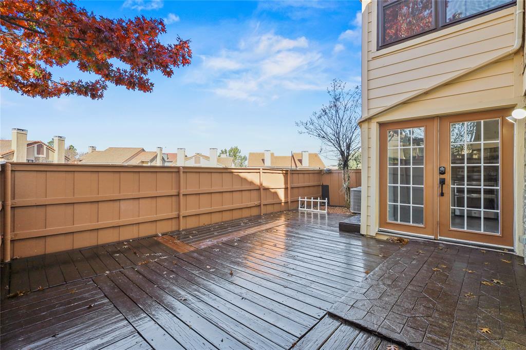 a view of a terrace with wooden floor and fence