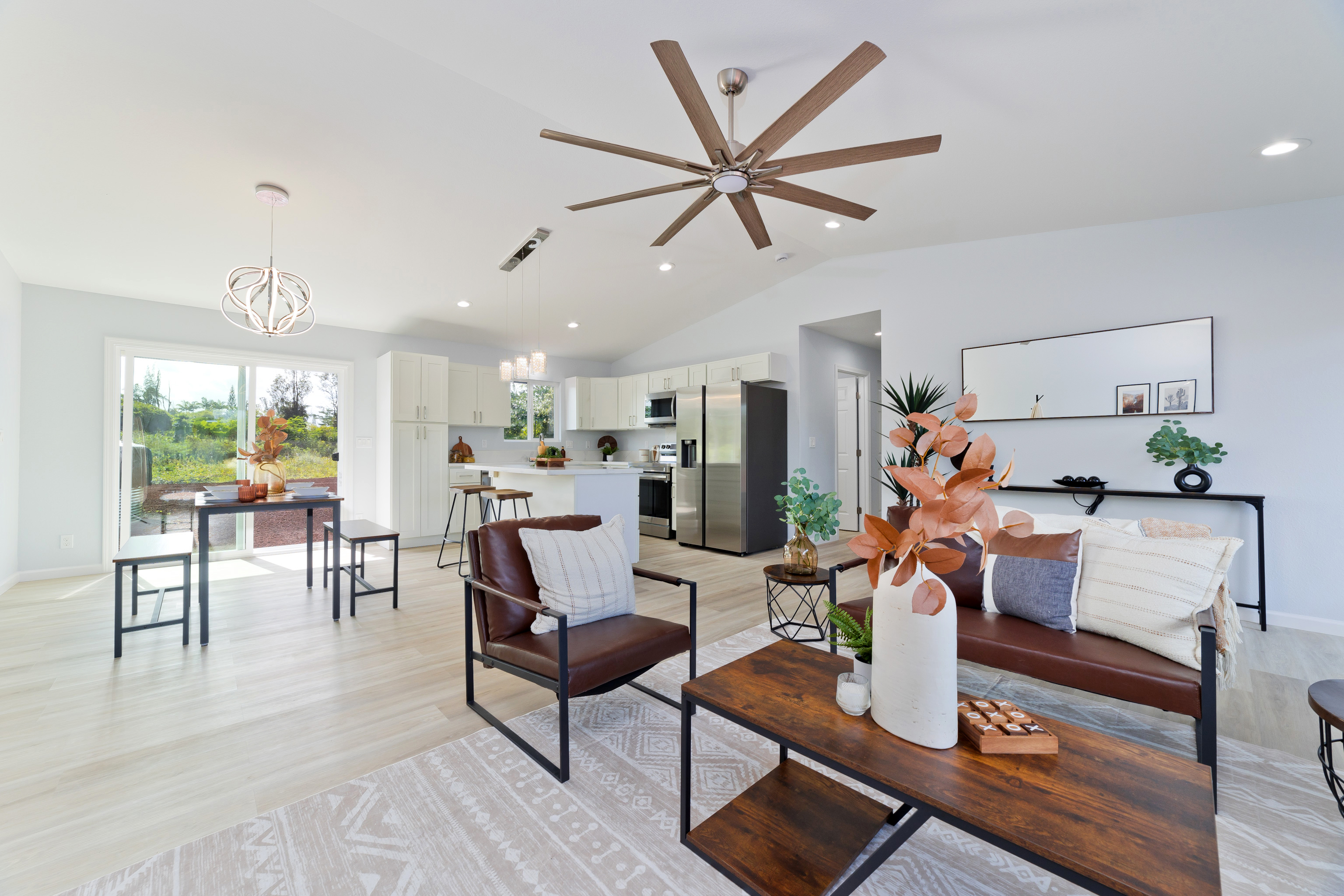 a living room with furniture and a view of kitchen