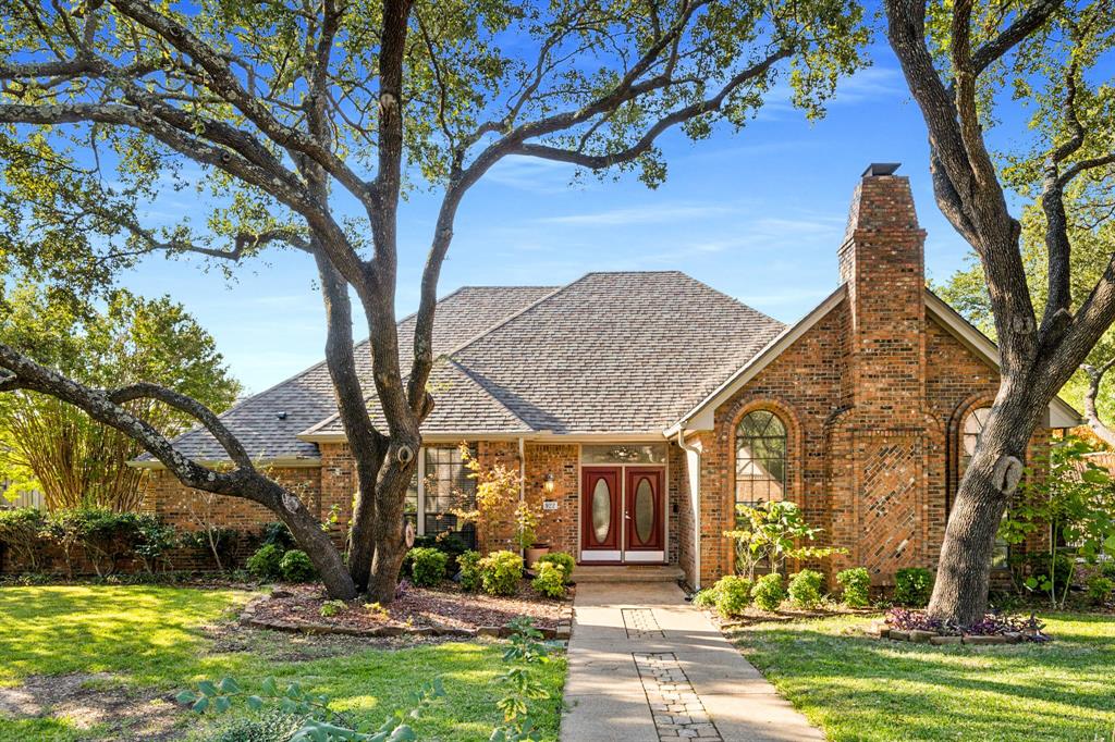 a view of a house with a tree in a yard