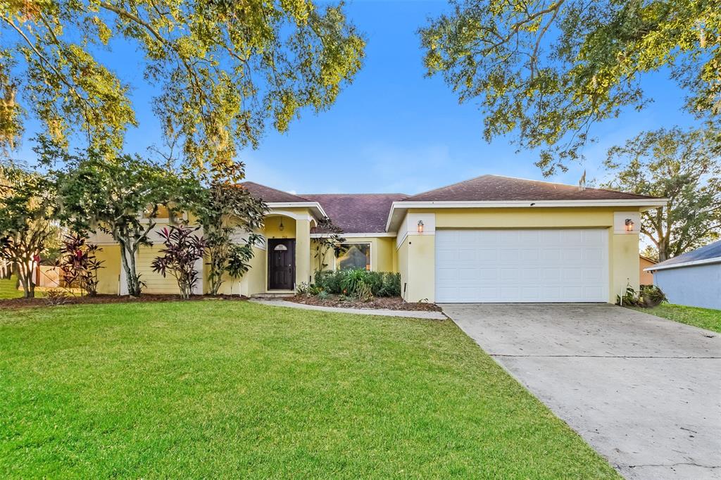 a front view of a house with a yard and garage