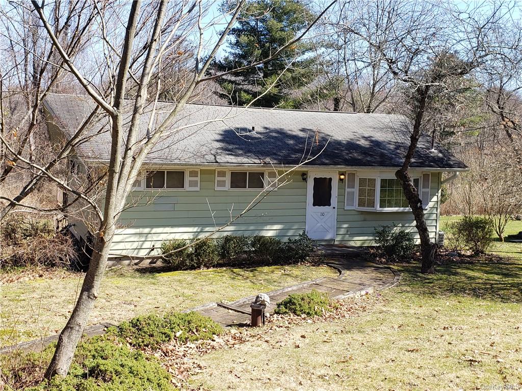 a view of a house with a yard covered in snow