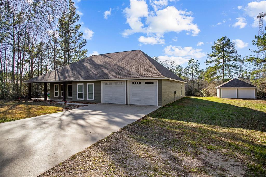 a view of a house with a yard and a garage