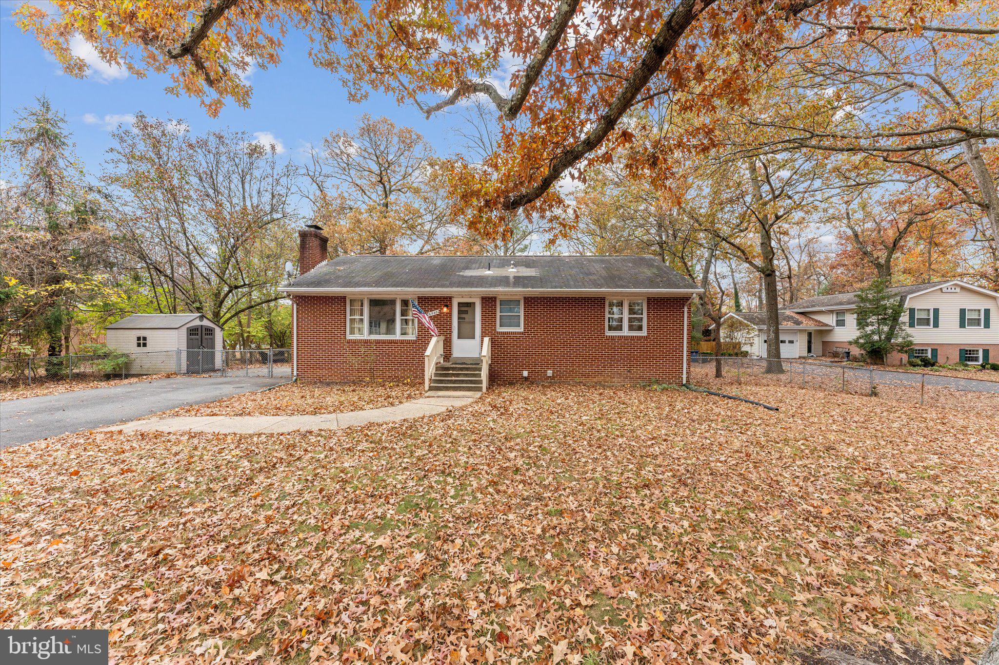 a front view of a house with a yard covered with snow