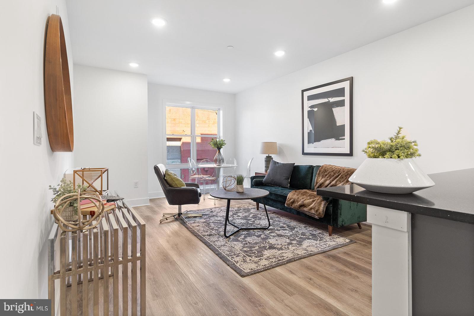 a living room with furniture a rug and a wooden floor