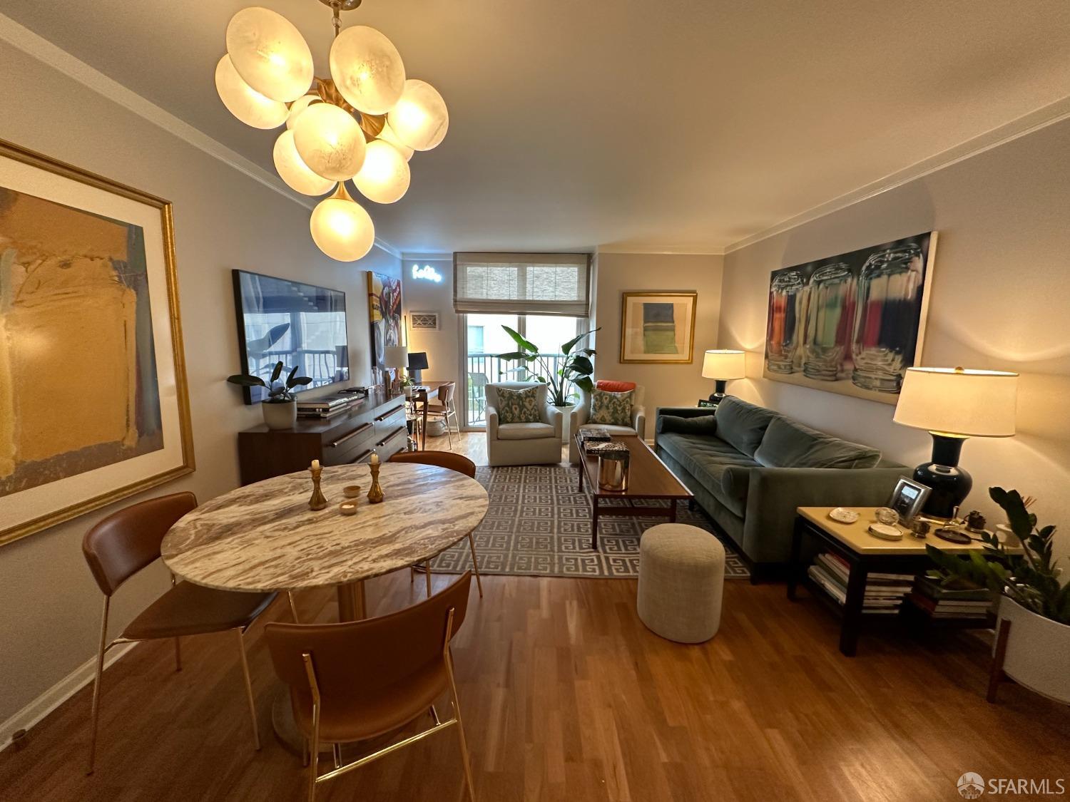 a living room with furniture a dining table and large windows