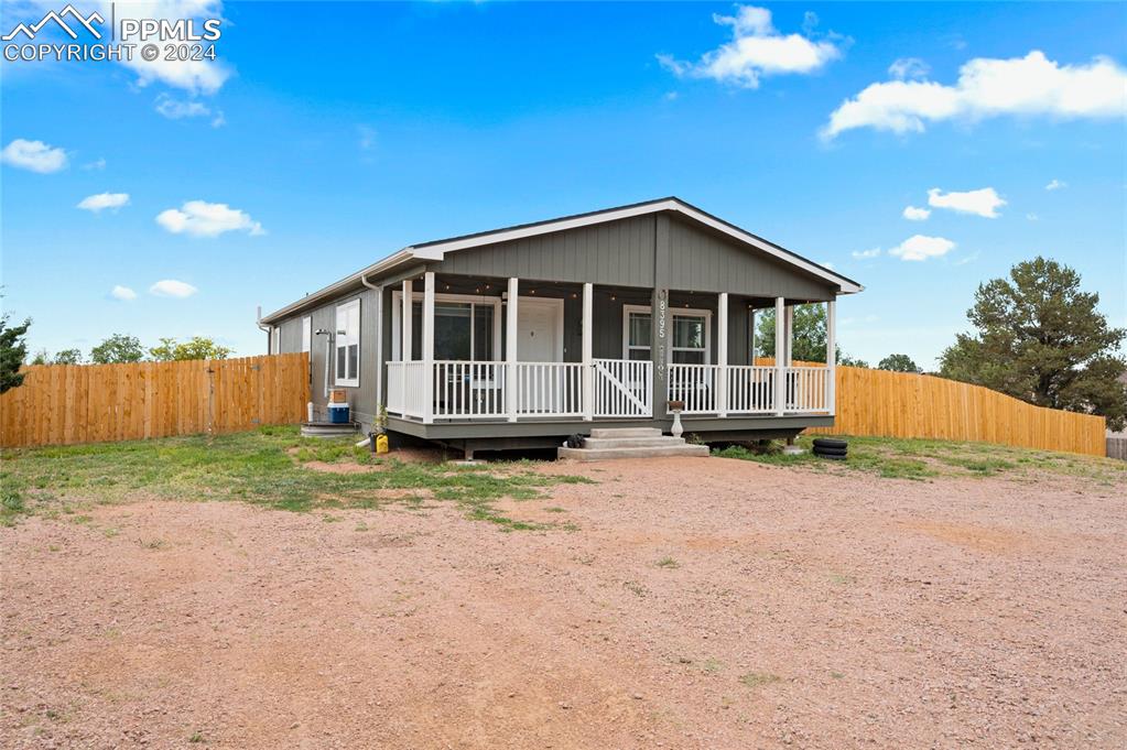 a front view of a house with a yard outdoor seating and barbeque oven