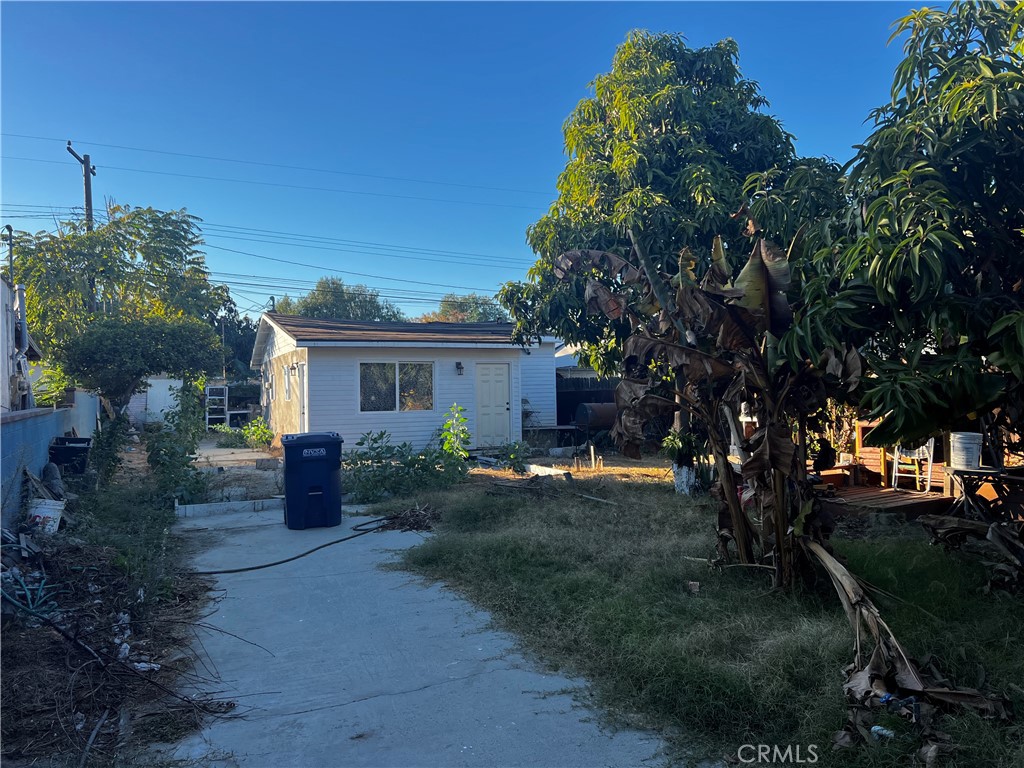 a front view of house with a garden