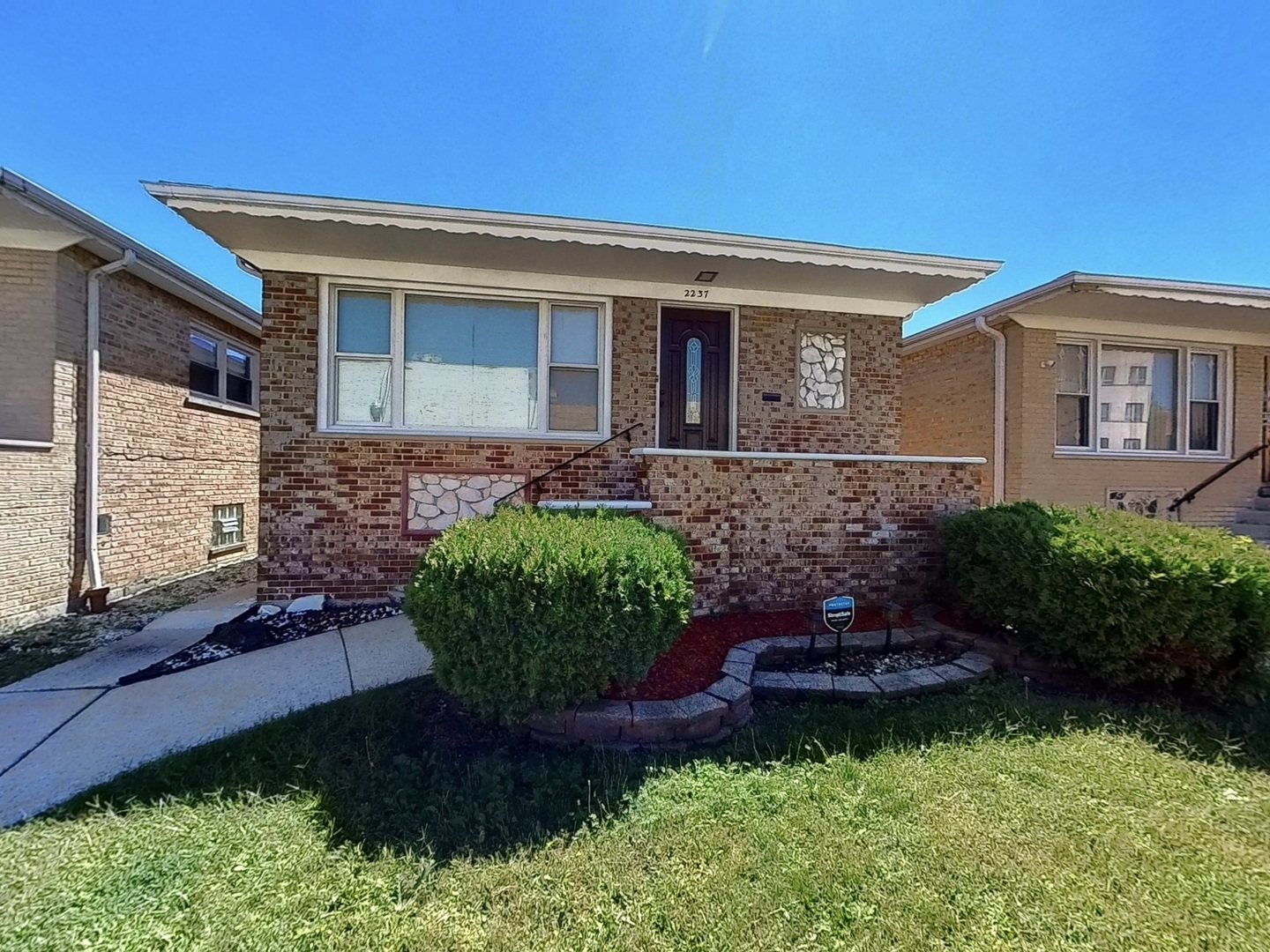 a front view of a house with garden