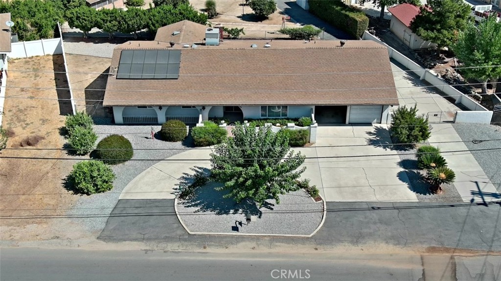 a aerial view of a house with a yard and potted plants