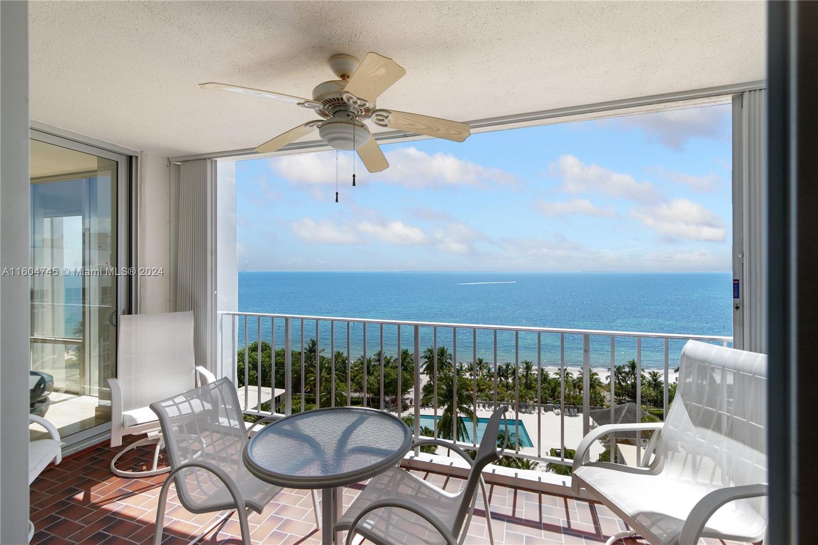 a view of a balcony dining table and chairs