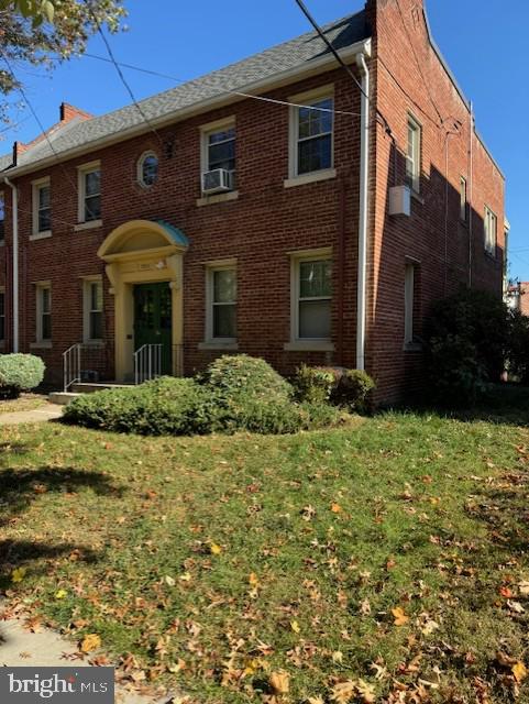 a view of a brick house with a yard