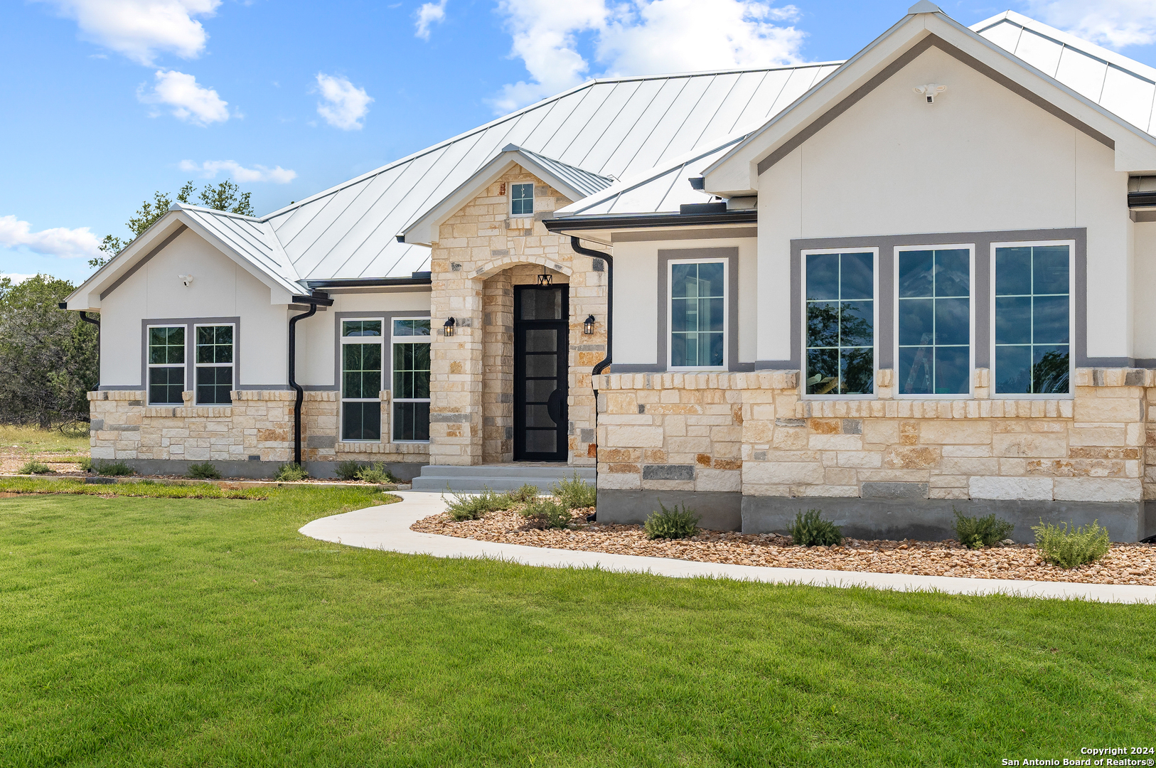 a front view of a house with a yard