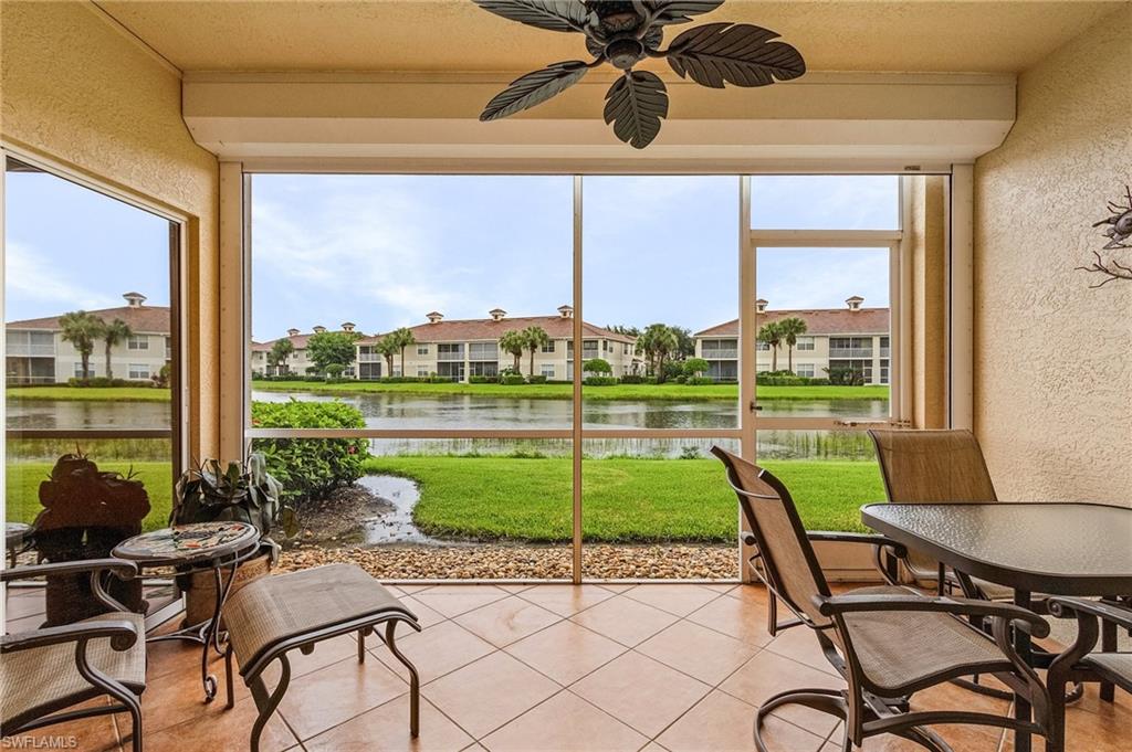 a view of a porch with furniture and a yard