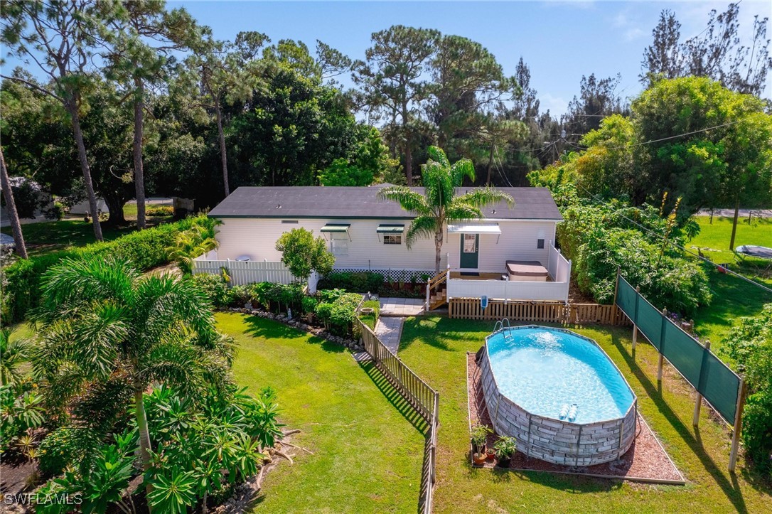 an aerial view of a house with swimming pool and garden