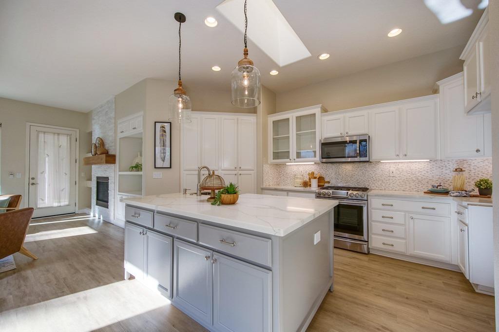 a kitchen with stainless steel appliances a sink stove and refrigerator