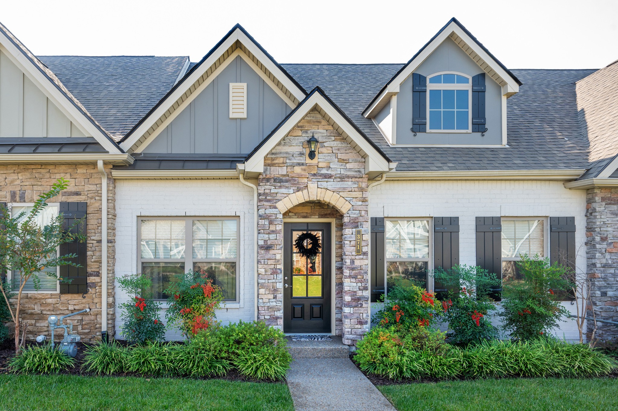 a front view of a house with garden