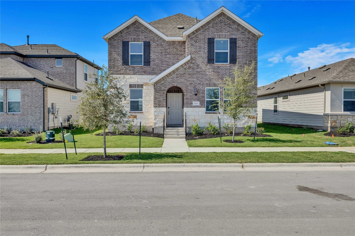 a front view of house with yard and green space