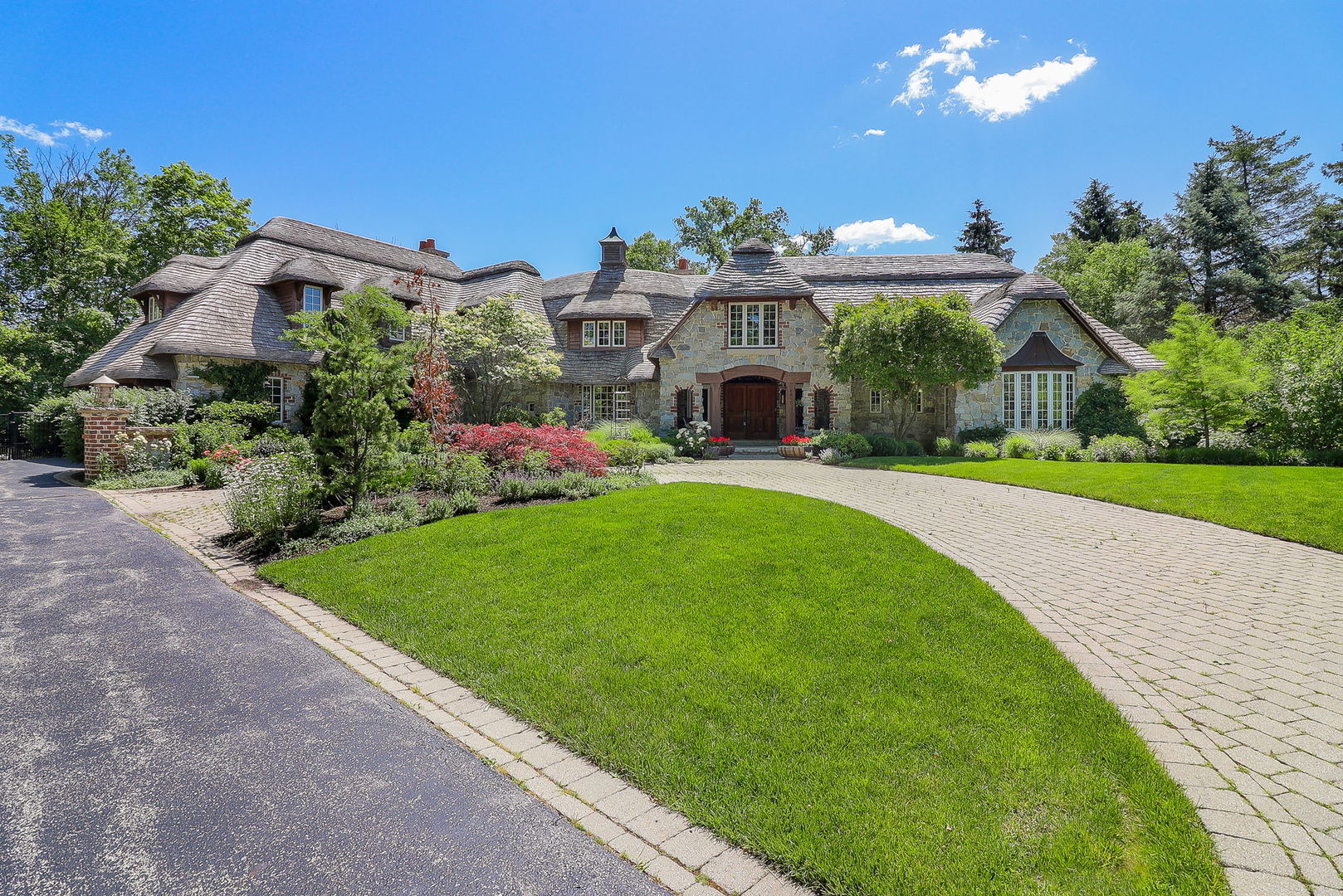 a view of a house with a yard and potted plants