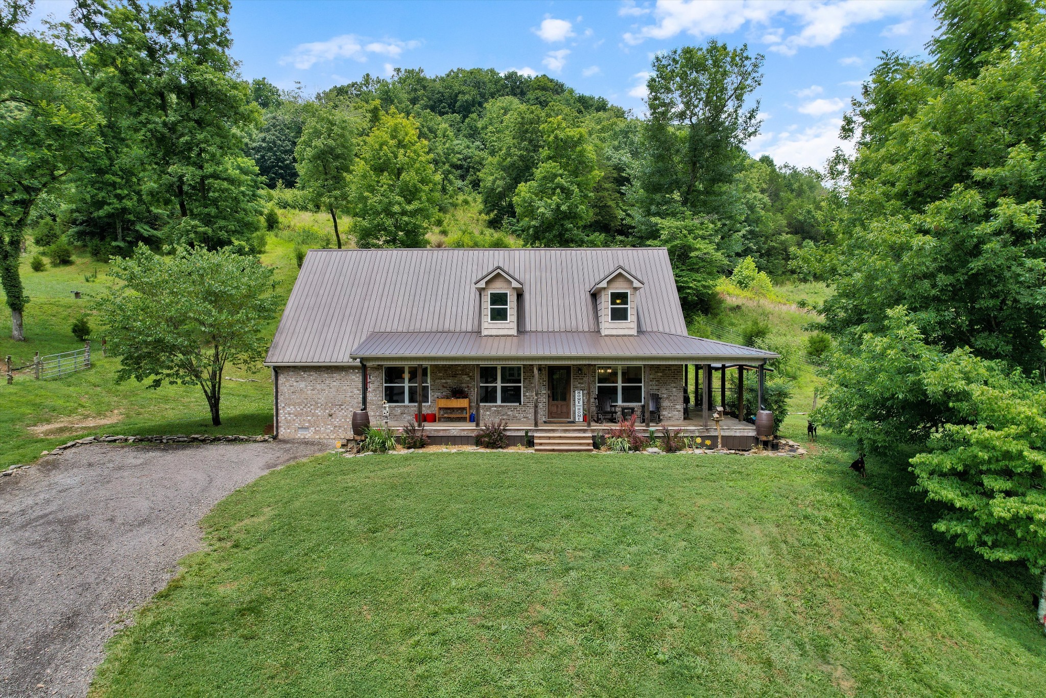 aerial view of a house with garden and trees