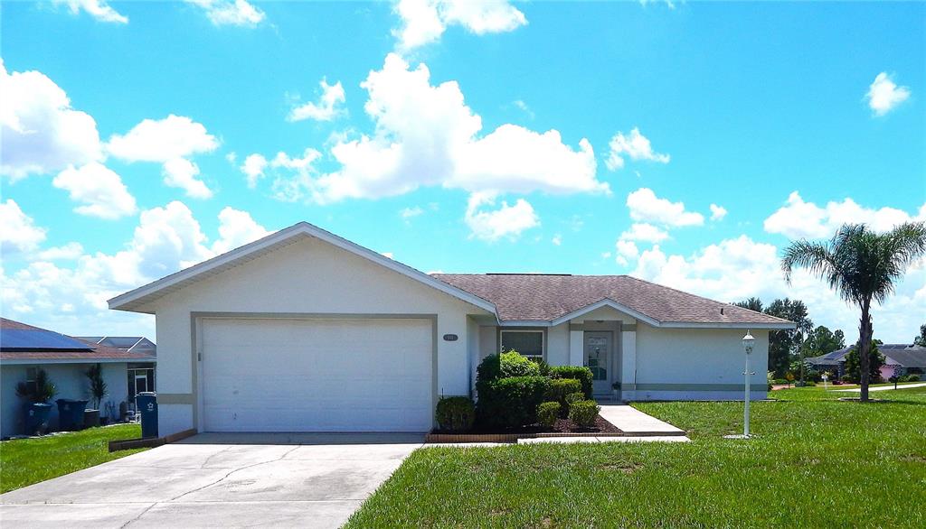 a front view of a house with a garden and yard