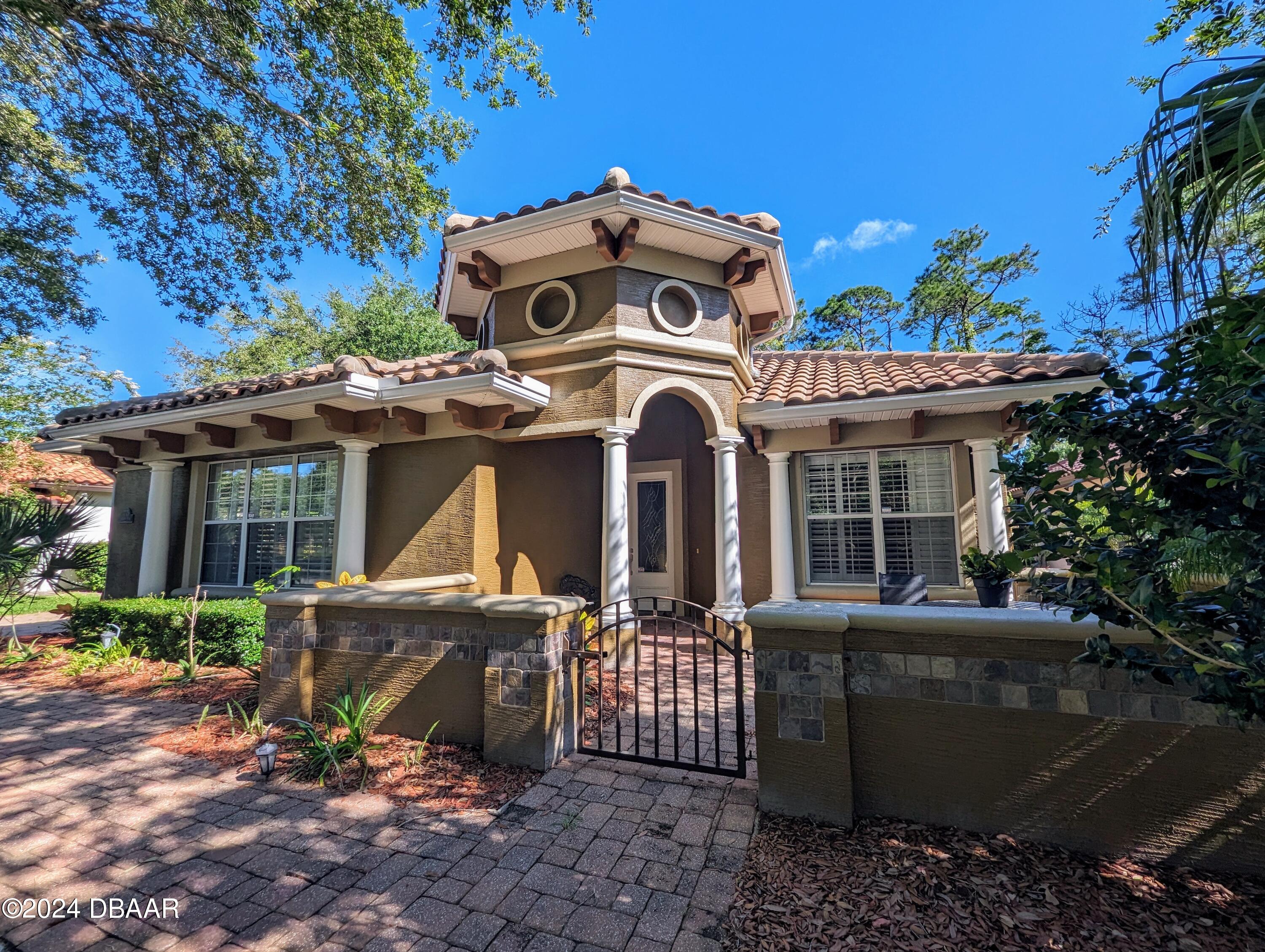 a view of a house with a patio and a garden