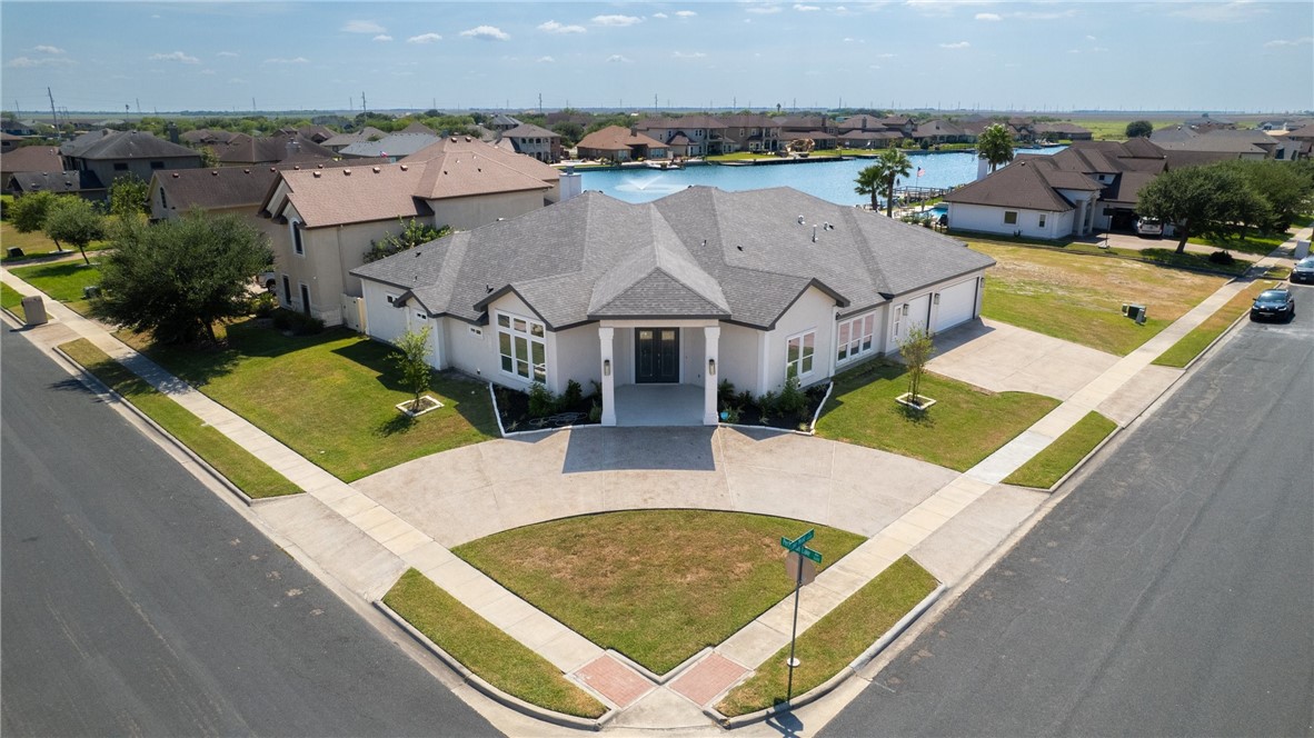 an aerial view of residential houses with outdoor space and swimming pool