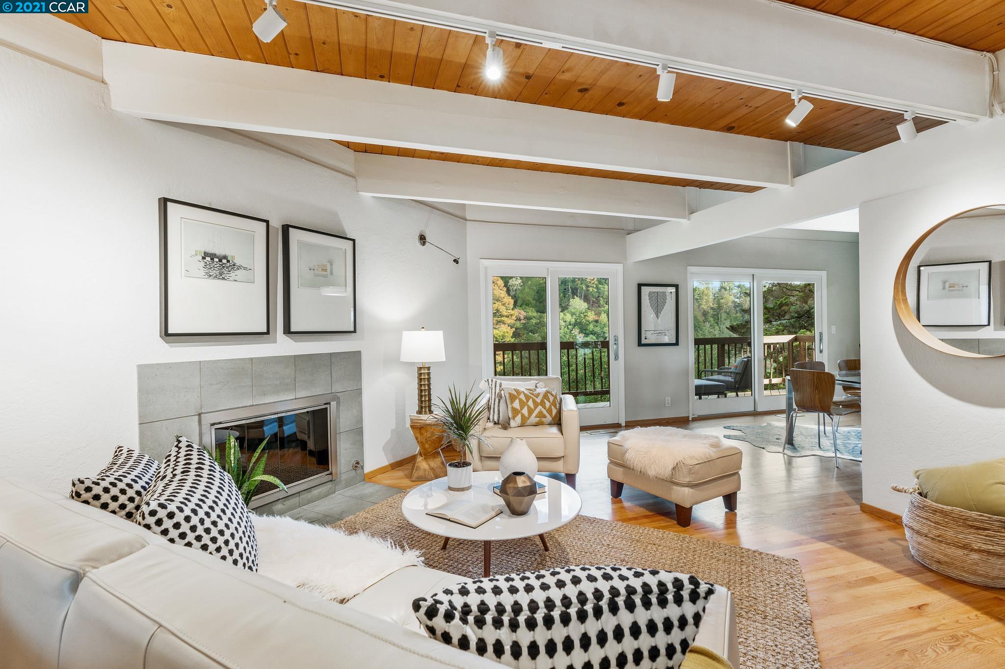 a living room with furniture a fireplace and a table