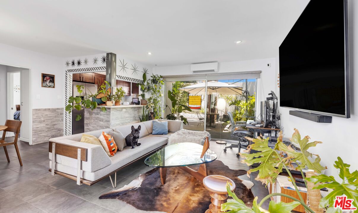 a living room with fireplace furniture and a flat screen tv