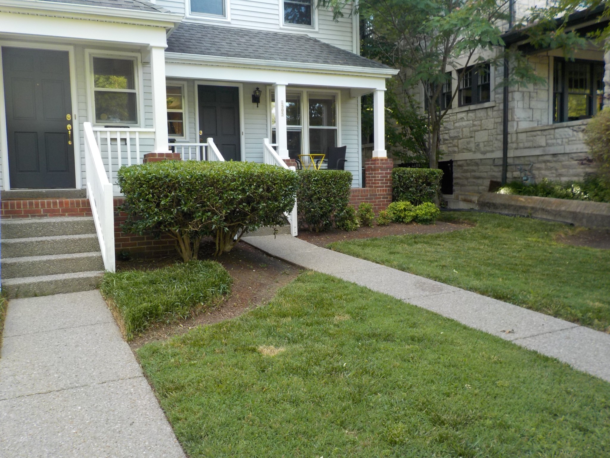 a view of house with a yard and sitting space