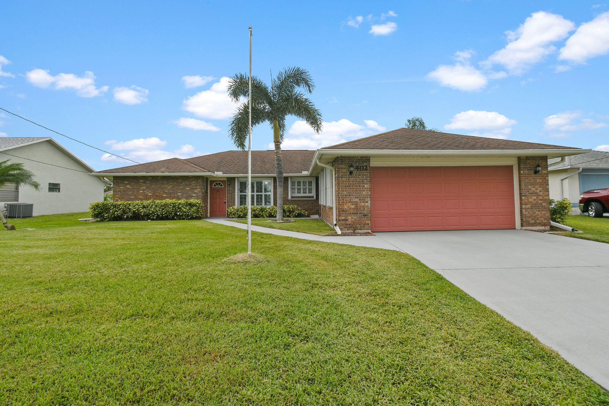 a front view of a house with a garden and yard