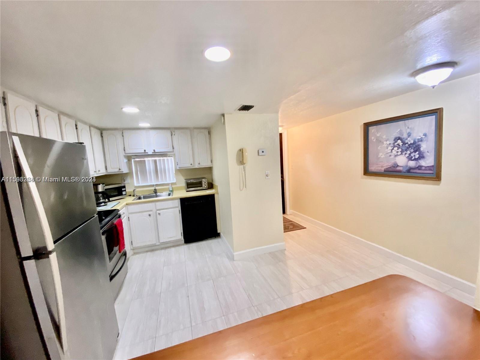 a kitchen with stainless steel appliances kitchen island a refrigerator sink and stove