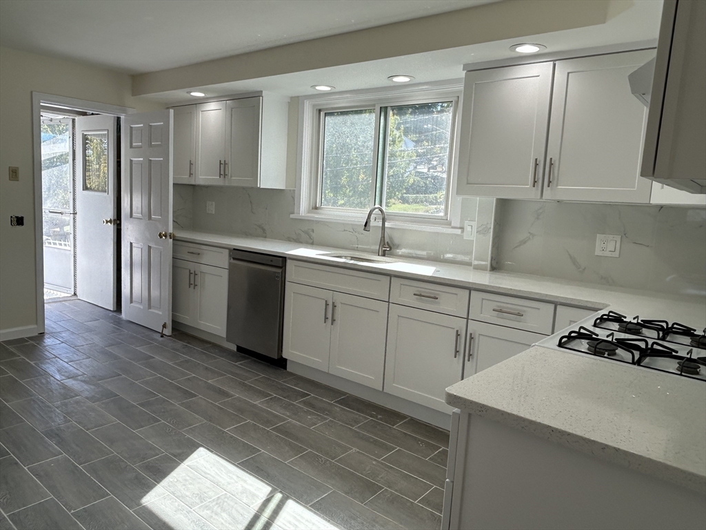 a kitchen with a sink stove and cabinets