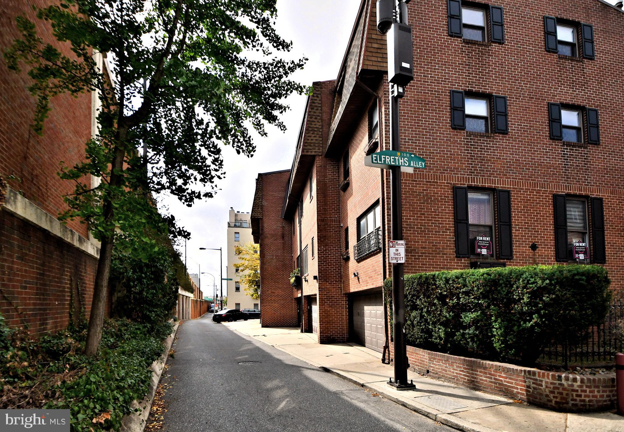 a view of a brick house next to a yard