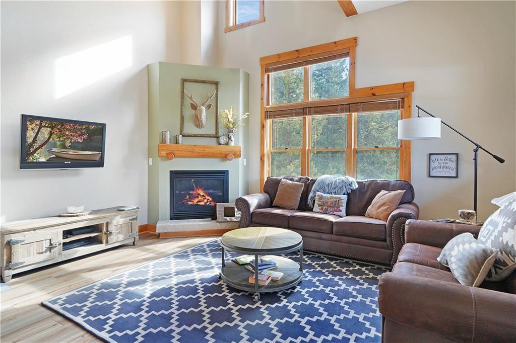 a living room with furniture a window and a fireplace