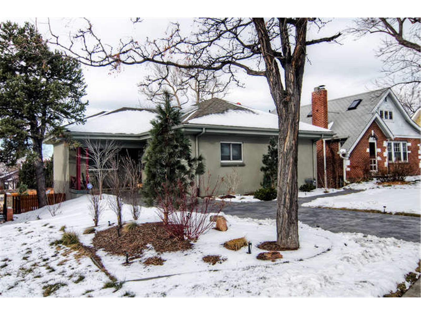 a front view of a house with a yard covered in snow