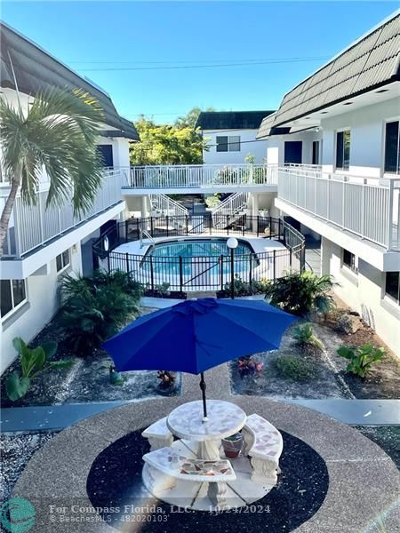 a swimming pool with outdoor seating and yard