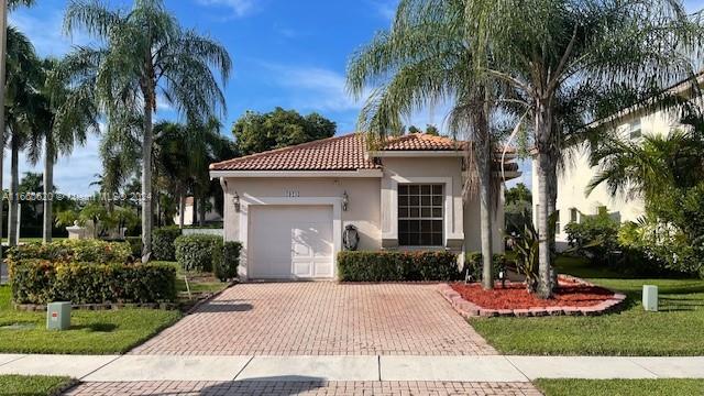 front view of a house with a yard and palm trees