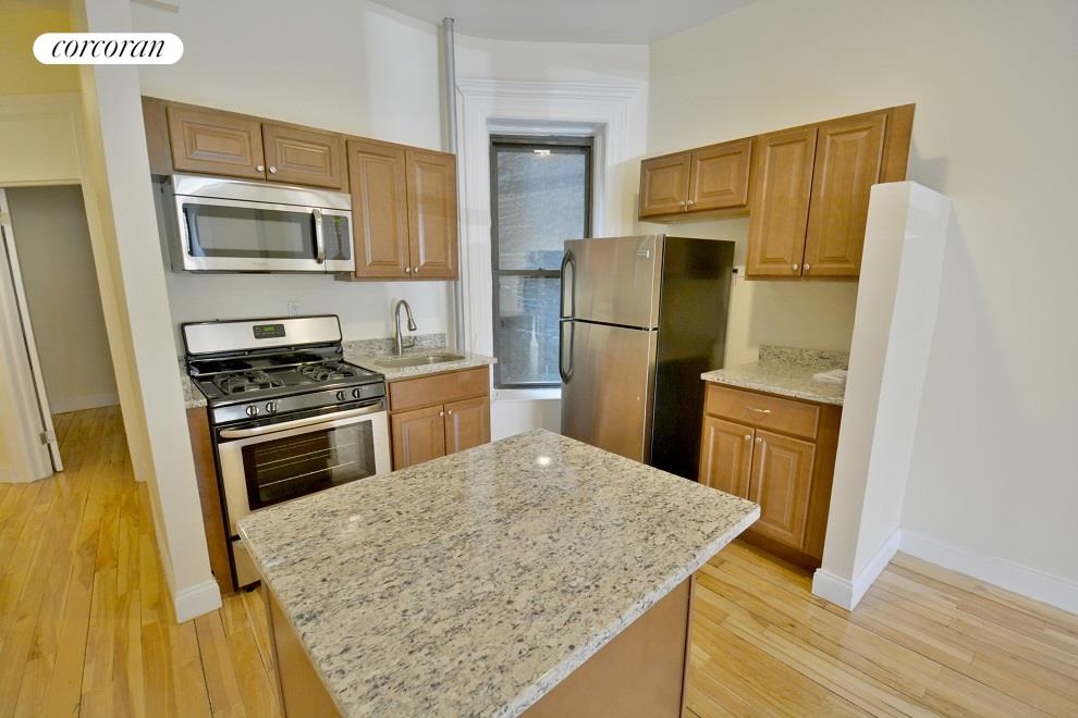 a kitchen with a refrigerator sink and microwave