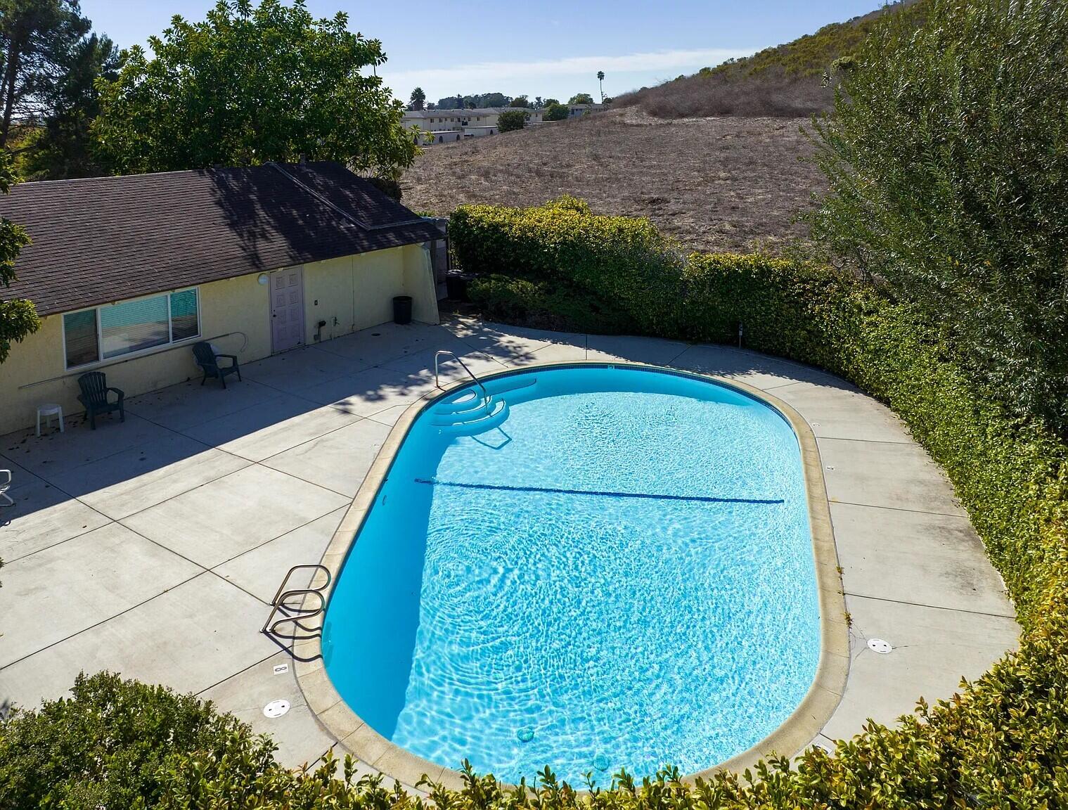 a view of a swimming pool with a yard