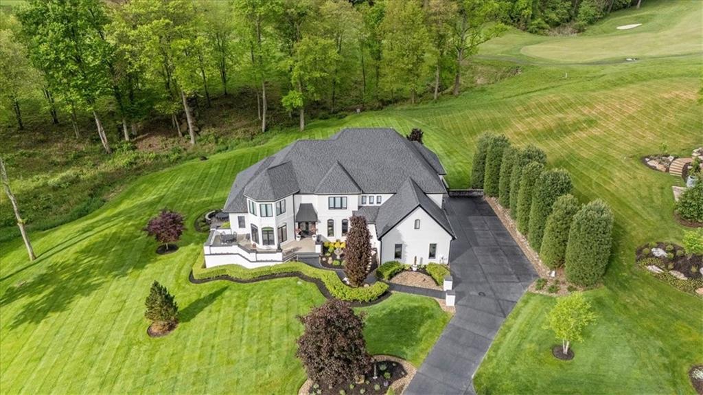 an aerial view of a house with swimming pool garden and patio