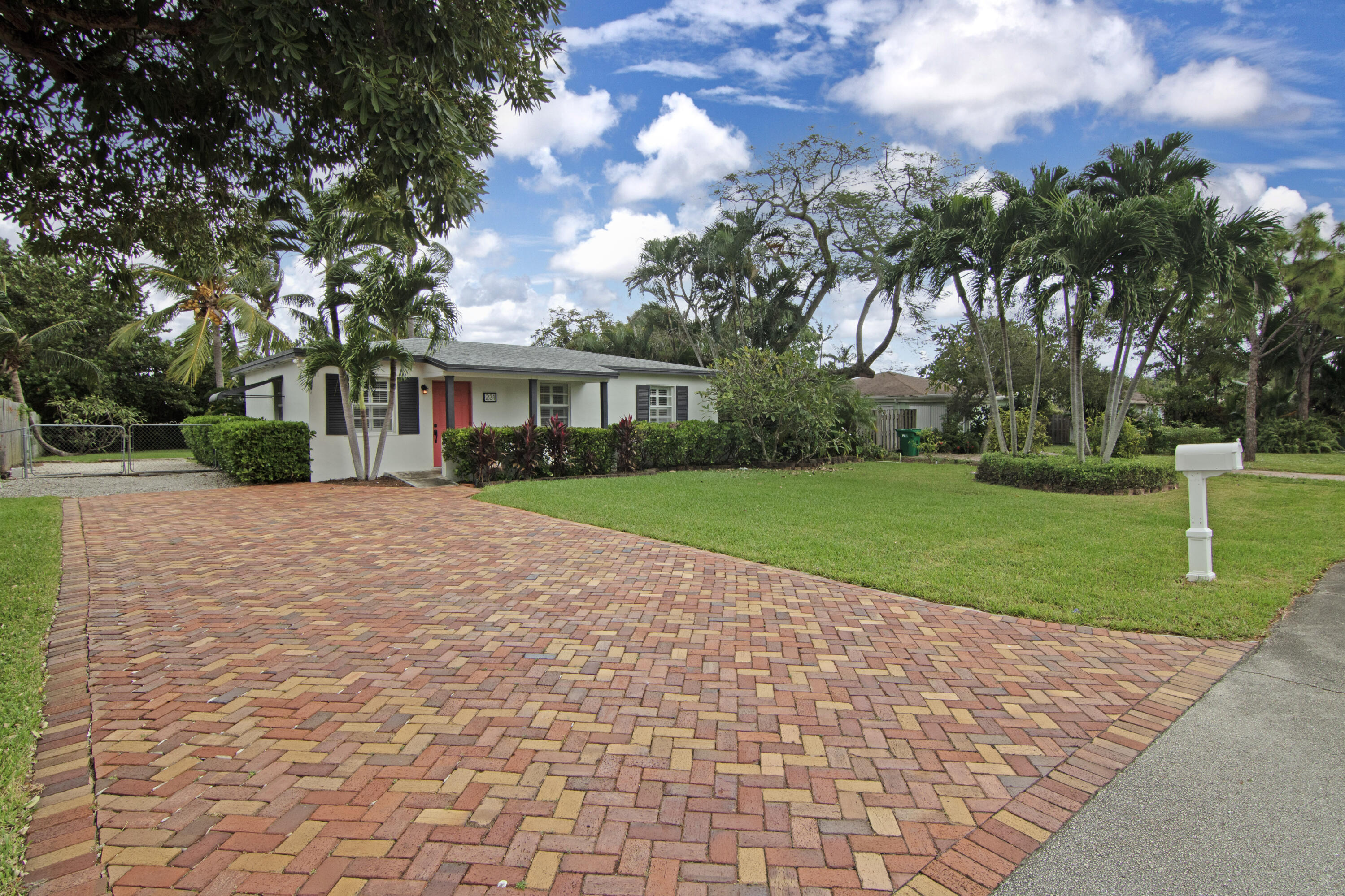 a view of house with outdoor space and garden