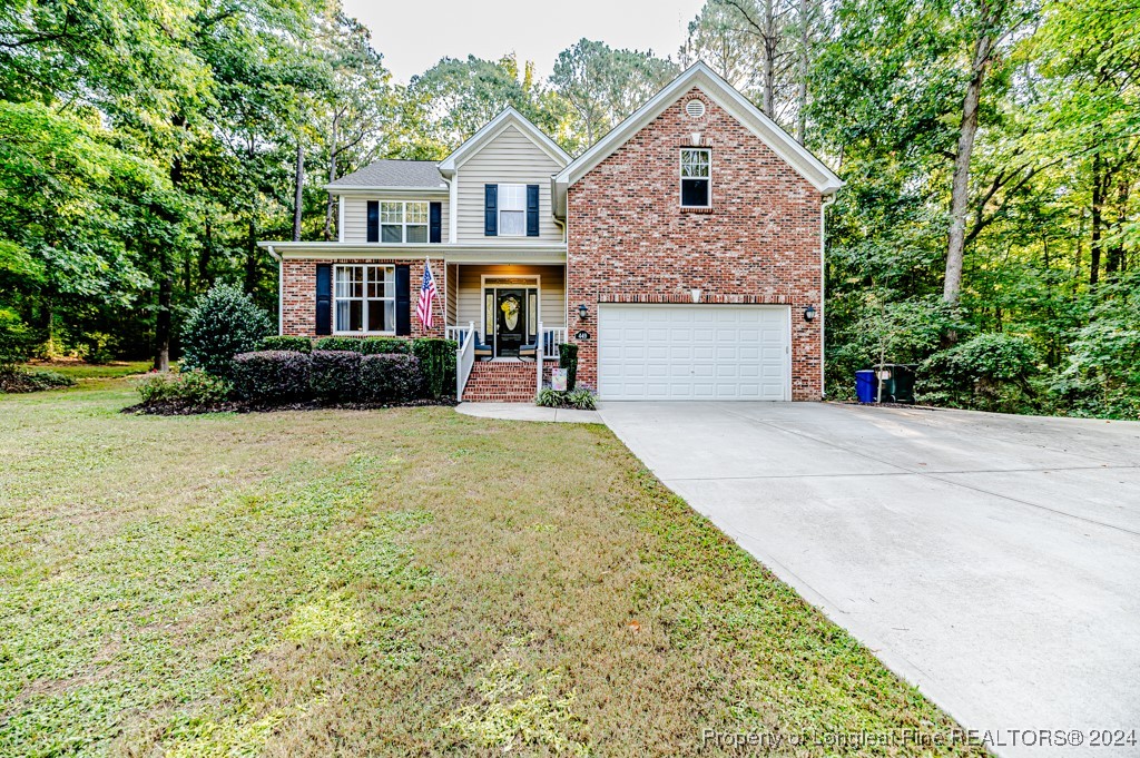 a front view of a house with a yard and garage