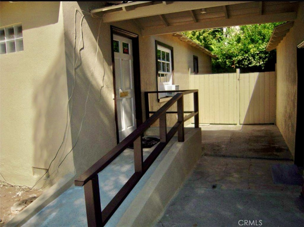 a view of balcony with wooden floor and fence