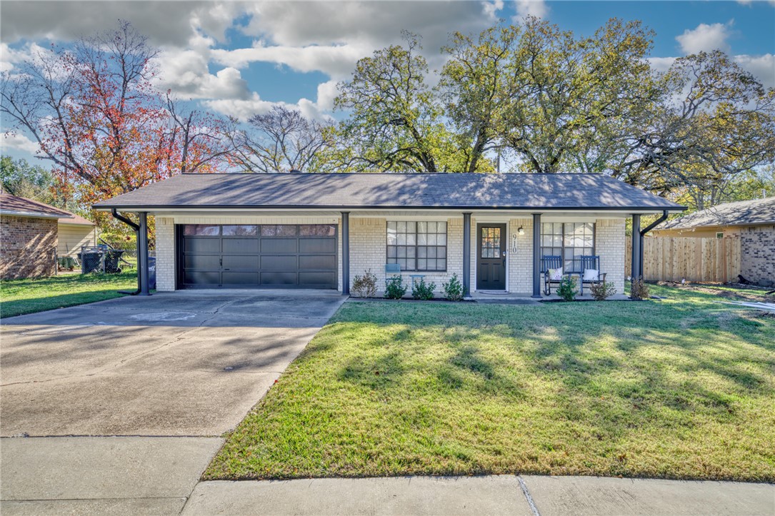 Ranch-style house with covered porch, a garage, an